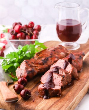 Grilled pork tenderloins are topped with a sweet and savory cherry balsamic sauce made with dark sweet cherries, cherry preserves, and balsamic vinegar.