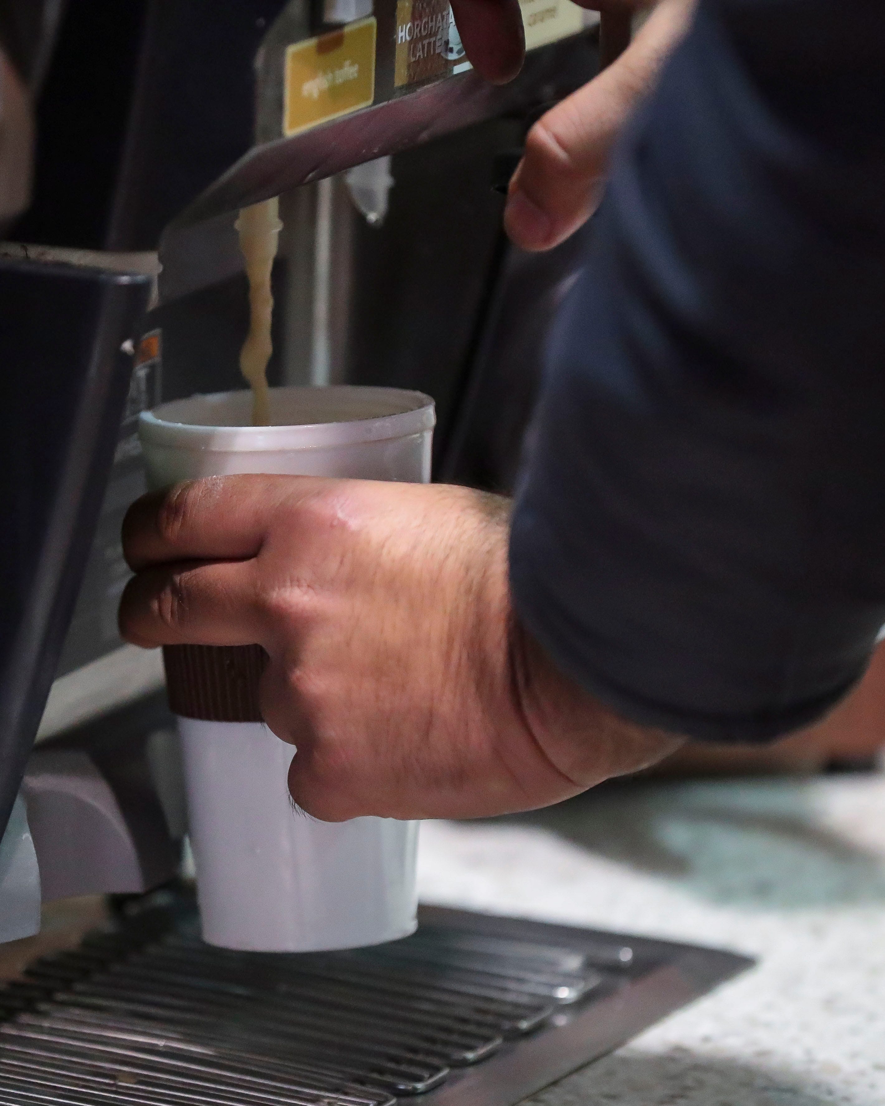 A customer fills his cup with cappuccino oat the Kwik Trip store in Plover.