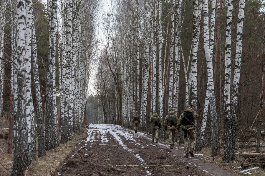 Ukrainian officers patrol at a checkpoint on the border with Belarus on Feb. 21.