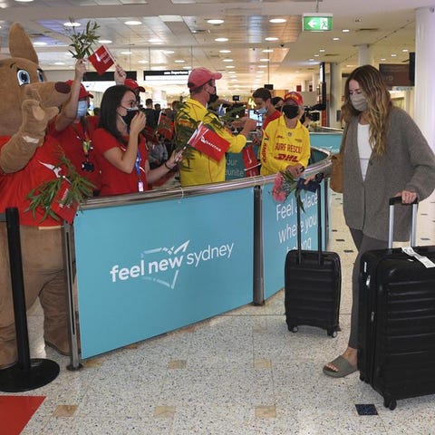 Passengers are welcomed as they arrive at Sydney I