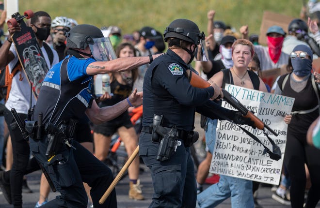Austin police officers clash with protesters during the May 2020 social justice protests.