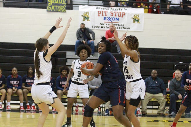 The Lady Gators double team West Monroe’s Shamiya Butler, who scored 25 in the Lady Rebels’ victory.