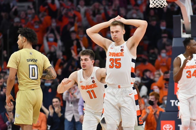 Feb 21, 2022; Syracuse, New York, USA; Syracuse Orange guard Buddy Boeheim (35) and guard Joseph Girard III (11) react to winning a game in overtime against the Georgia Tech Yellow Jackets at the Carrier Dome. Mandatory Credit: Mark Konezny-USA TODAY Sports