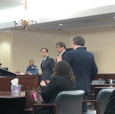 Defendant Jamison Mullins, left, and defense attorney Chase Smith, middle, listens to Assistant District Attorney Dan Brollier in Judge William Goodmans III courtroom at Montgomery County courthouse Tuesday Feb. 22, 2022