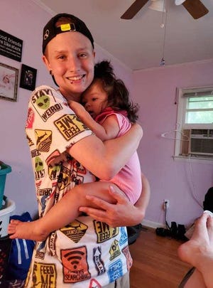 Matthew Spampinato holds his cousin Morgan Hanners' daughter, Athena.