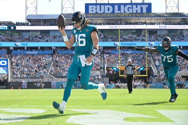 Jacksonville Jaguars quarterback Trevor Lawrence (16) celebrates his 4-yard rushing touchdown during the second half of an NFL football game against the Tennessee Titans, Sunday, Oct. 10, 2021, in Jacksonville, Fla.