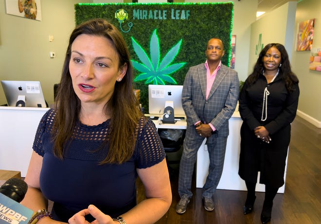 Nikki Fried talks about medical marijuana, with Black entrepreneurs Jonathan and Dr. Antoinette Smith in back, after as touring their medical marijuana doctor’s office and retail store, Miracle Leaf of Southern Boulevard, in West Palm Beach Wednesday, February 23, 2022. The couple have one of the few minority-owned enterprises in the cannabis industry.