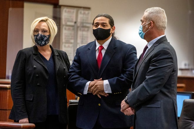 Jose Larin-Garcia, center, looks toward his family during a break in the final arguments of his trial in Indio, Calif., on Wednesday, Feb. 23, 2022. 