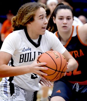 West York's Faith Walker drives against Palmyra's Maddie Henry in a District 3 Class 5-A first-round game at West York Tuesday, Feb. 22, 2022. West York would win 37-29. Bill Kalina photo