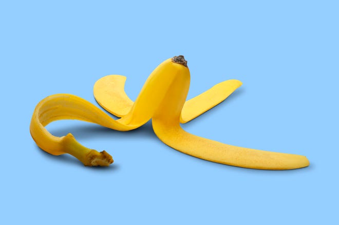 A yellow banana peel on a blue background.