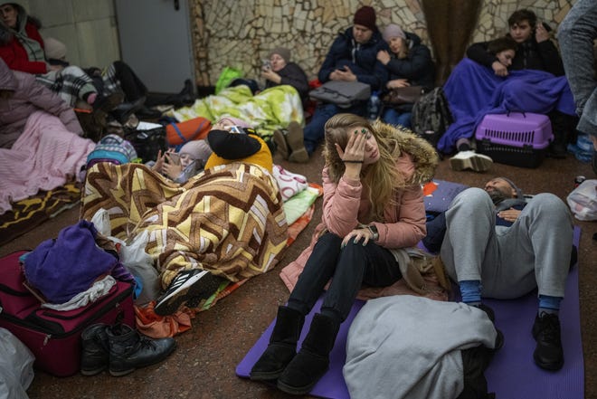 People rest in the Kyiv subway, using it as a bomb shelter in Kyiv, Ukraine, Thursday, Feb. 24, 2022. Russia has launched a full-scale invasion of Ukraine, unleashing airstrikes on cities and military bases and sending troops and tanks from multiple directions in a move that could rewrite the world's geopolitical landscape.