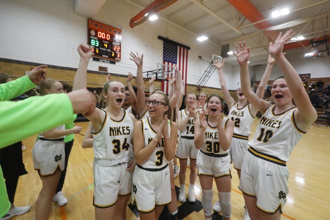  Notre Dame High School players celebrate the teamâ€™s 83-22 Class 1A regional final victory over English Valley Wednesday Feb. 23, 2022 at Fairfield High School.  