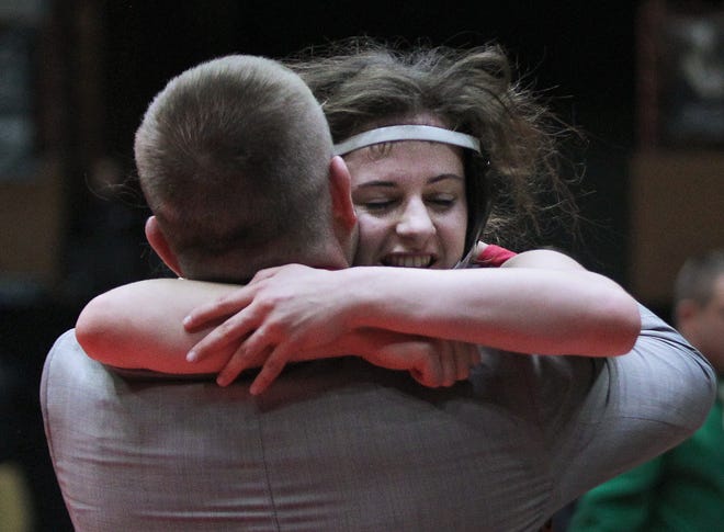 Rossville's Kendra Hurla hugs her coach Courtney Horgan after defeating Pratt's Jadyn Thompson in the championship match of the 120-pound weight class at the KSHSAA Class 4-1A girls state wrestling championship Thursday at Tony's Pizza Event Center in Salina.