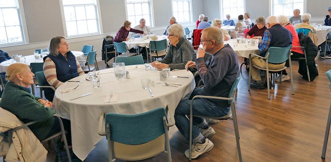 Senior wait for a meal of baked haddock, carrots and baked potatoes cooked by Fred Willette, 67, of Cohasset. The retired chef works four days a week at the Scituate Senior Center.