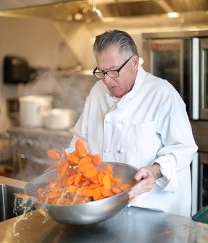 Fred Willette tosses boiled carrots with sugar thyme and sesame seeds.