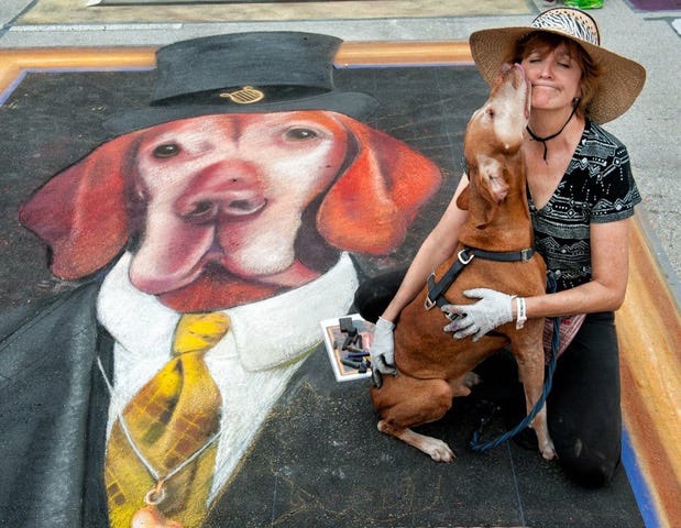 Lake Worth Beach artist Genie Burns and her dog Apollo share love at the 2016 festival.