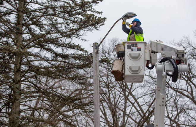 Worker Rob Greathouse replaces old street lamps with new LED lights on Wednesday, Feb. 23, 2022, in the LaSalle Area neighborhood in South Bend. 