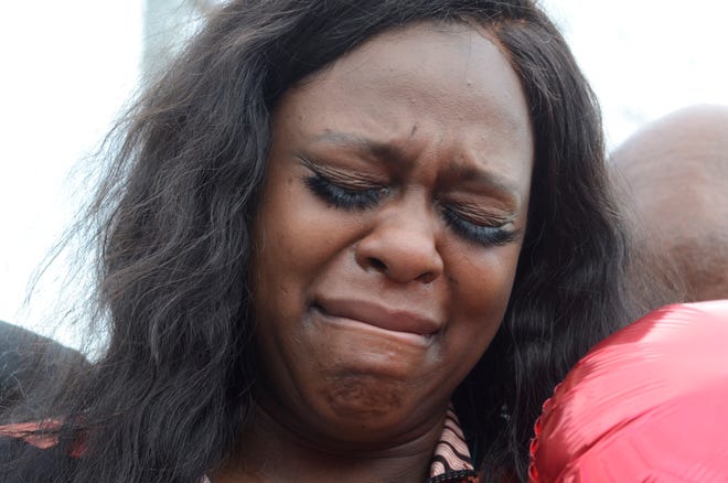 Kyoukius Washington cries before releasing a balloon in memory of her son Oterious 'Bull' Marks, who died in a drive-by shooting, Central Park in McComb, Miss., on Monday, Feb. 21, 2022. A drive-by shooting at a Mississippi park left a 6-year-old boy dead and four others wounded, authorities said.