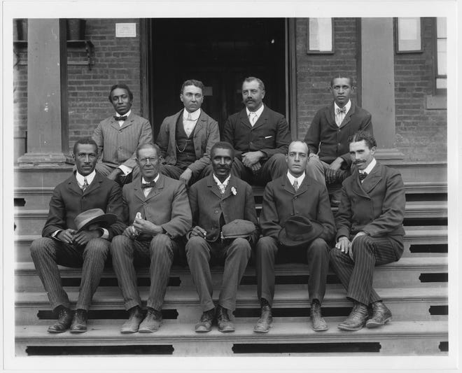 This 1902 portrait provided by The Library of Congress shows George Washington Carver, front row, center, seated with other staff members on the steps of Tuskegee Normal and Industrial Institute in Tuskegee, Alabama.