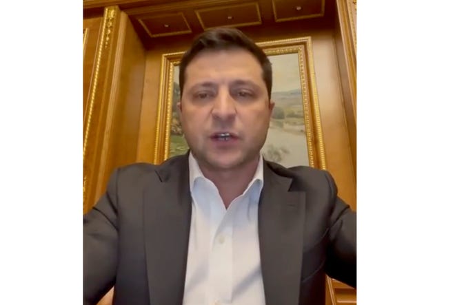 In this handout photo taken from video provided by the Ukrainian Presidential Press Office, Ukrainian President Volodymyr Zelenskyy addresses to the nation in Kyiv, Ukraine, Thursday, Feb. 24, 2022. Zelenskyy declared martial law, saying Russia has targeted Ukraine's military infrastructure. He urged Ukrainians to stay home and not to panic.