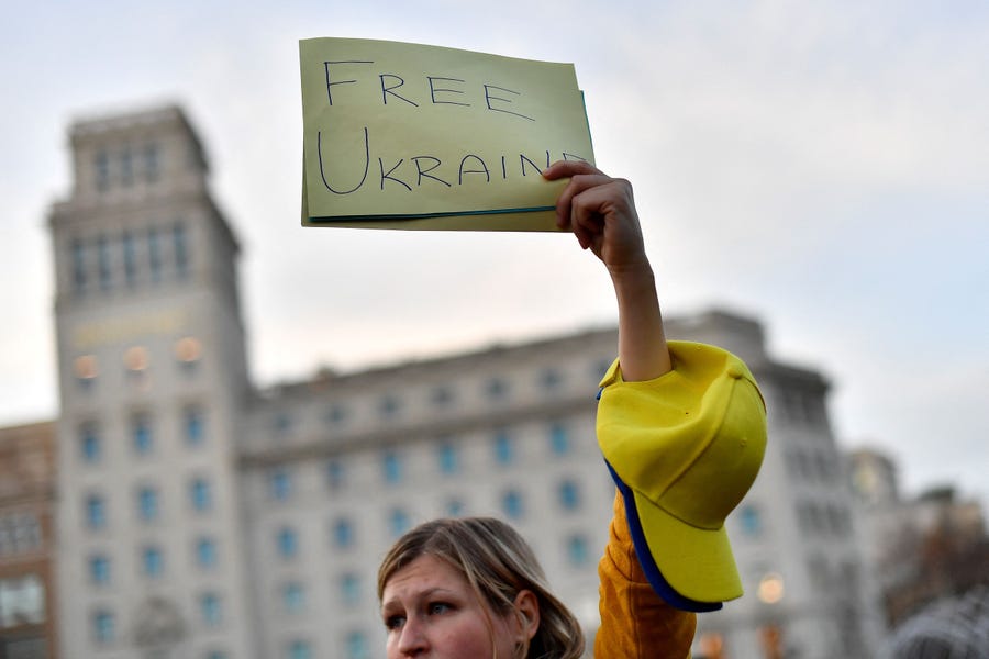 A demonstrator holds a sign reading "Free Ukraine" during a protest against Russia's military operation in Ukraine, in Barcelona on February 24, 2022. - Russia's President Vladimir Putin has launched a military operation in Ukraine on February 24, 2022 after weeks of intense diplomacy and the imposition of Western sanctions on Russia that failed to deter him. (Photo by Pau BARRENA / AFP) (Photo by PAU BARRENA/AFP via Getty Images)