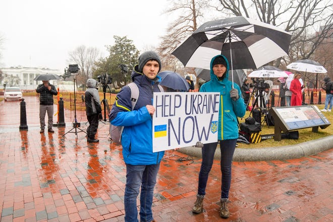 Pro-Ukraine demonstrators show their support at the White House in Washington on Feb. 24. Despite the good intentions of many, scammers and thieves look to take advantage of the Russia-Ukraine conflict.