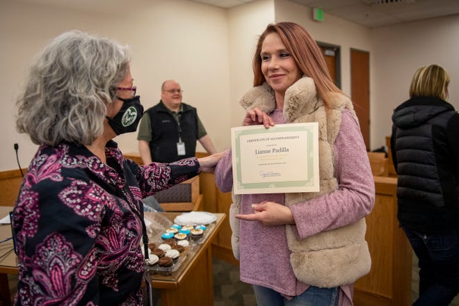 City of Fort Collins probation officer Bernadette Felix presents Right Track program graduate Lianne Padilla with a certificate upon her completion of the program, Feb. 24, 2022, at Fort Collins Municipal Court in Fort Collins, Colo.