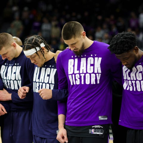 Sacramento Kings and Denver Nuggets players lock a