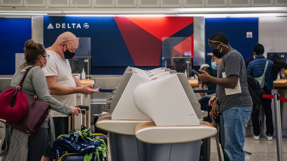 People check in at a Delta station for departing flights at the George Bush Intercontinental Airport on Jan. 13 in Houston.