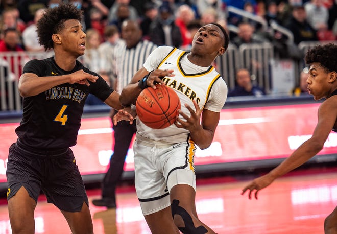 Quaker Valley's Adou Thiero goes up for a basket around Lincoln Park's L.A. Pratt, left, and Brandin Cummings during their WPIAL quarterfinal game at Robert Morris University.