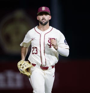 Florida State outfielder Reese Albert (23) runs to the dugout after the top of the inning. The Florida State Seminoles defeated the Samford Bulldogs 7-0 on Friday, Feb. 25, 2022.