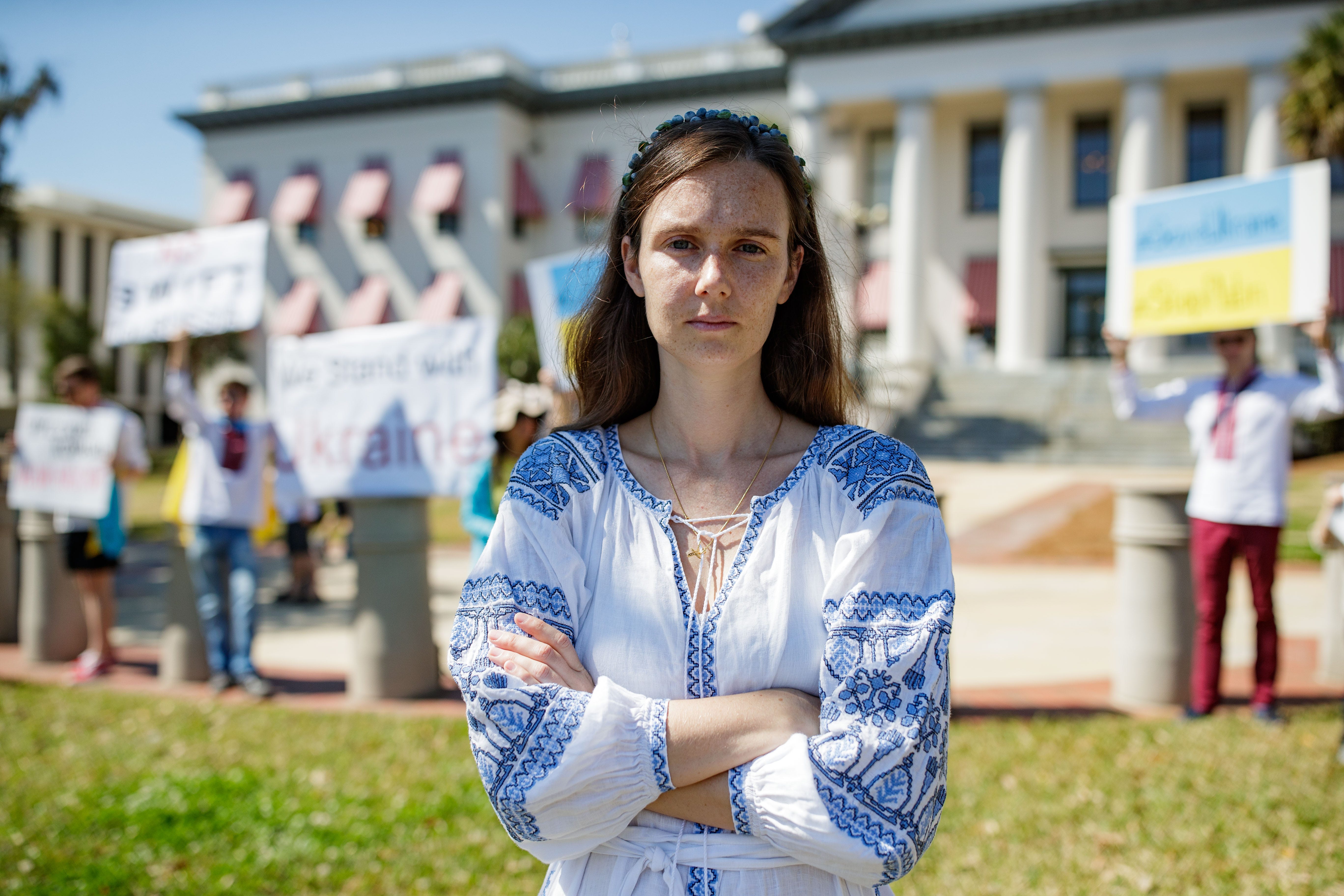 Anastasiia Vlasenko stands in front of others gathered at the Florida Capitol to rally for the Ukraine following the attack from Russia, Saturday, Feb. 26, 2022.