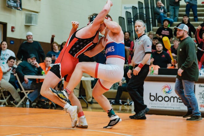West Holmes' Grant Miller and New Phila's Konnor Tetzloff wrestle during Division II sectional wrestling action Saturday at Claymont High School