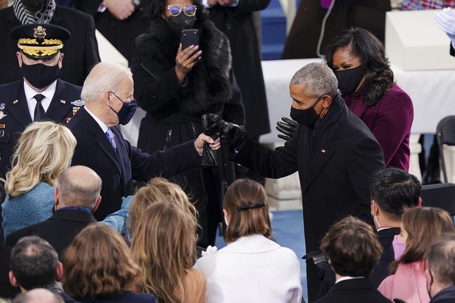 US President-elect Joe Biden (left) greets former US President Barack Obama,  with a fist bump during the inauguration of the 46th US President on Jan. 20, 2021, at the US Capitol in Washington, DC. (Kevin Dietsch/Pool/AFP via Getty Images/TNS)