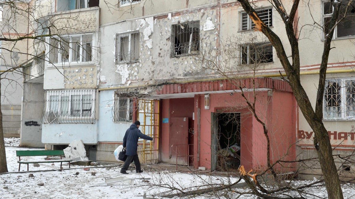 A view of a residential building damaged by recent shelling in Kharkiv on Feb. 26, 2022. - Russia ordered its troops to advance in Ukraine "from all directions" as the Ukrainian capital Kyiv imposed a blanket curfew and officials reported 198 civilian deaths.