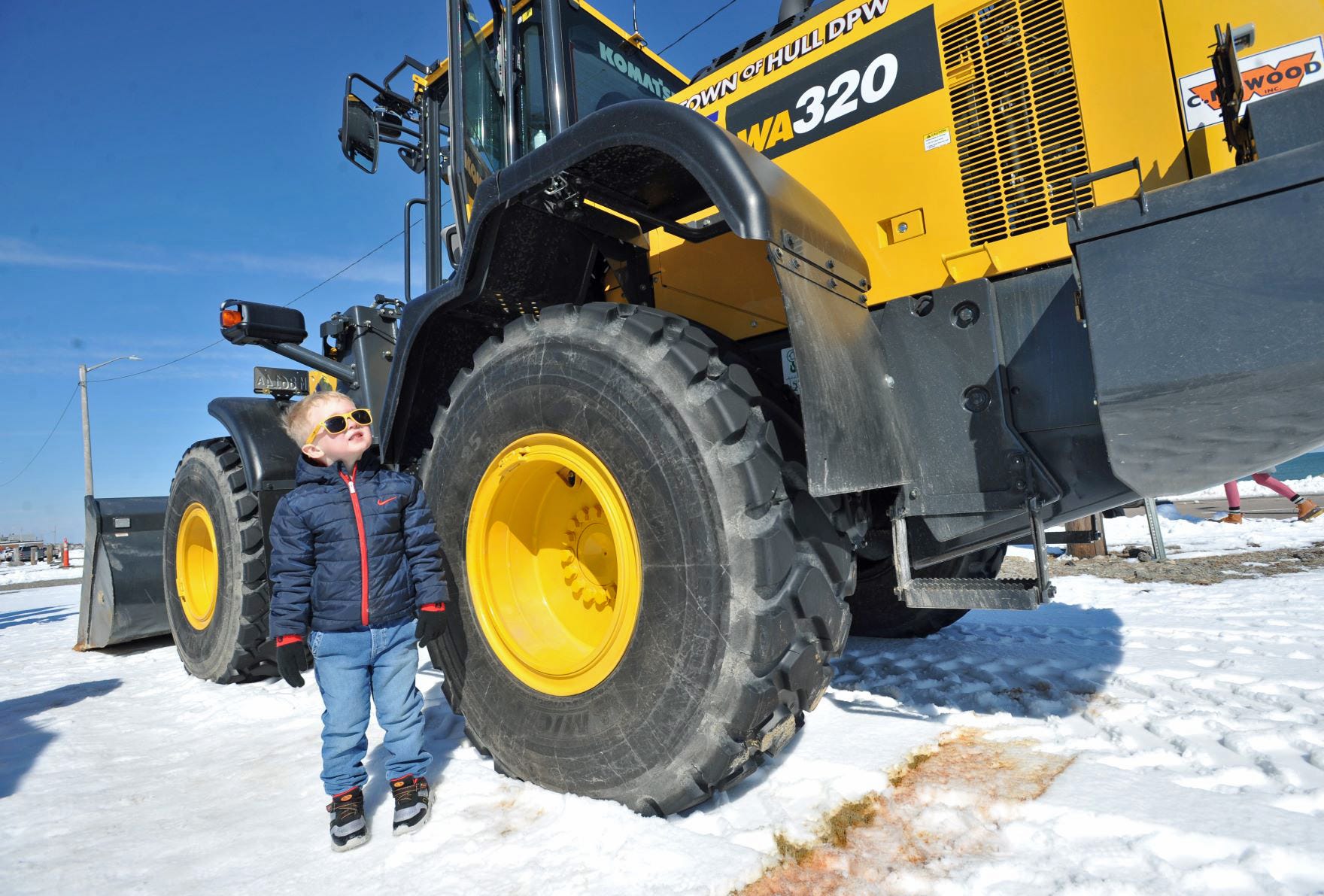 Henry O'Neill, 4, of Hanson, looks over a Hull DPW front-end loader during the Snow Show in Hull, featuring various vehicles, Sunday, Feb. 27, 2022. Tom Gorman/For The Patriot Ledger