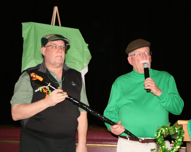 In 2016, former "Himself" Edward Sheridan (right) passed the shillelagh to current "Himself" Mark O'Toole. On March 12, O'Toole will award a shillelagh to Sheridan.