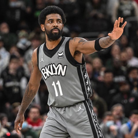 Brooklyn Nets guard Kyrie Irving reacts during a t