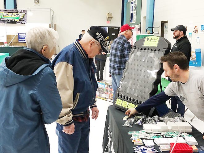 Patrons to the Farm and Home Show, held at Prairie Central Upper Elementary School in Forrest, look over items at the Bank of Pontiac table.