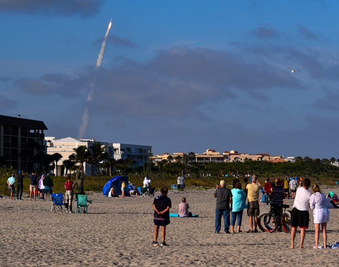 People on the beach in Cape Canaveral watch a recent launch of an Atlas V rocket from Launch Complex 41 at Cape Canaveral Space Force Station. Beaches and launches are among the top tourist draws to the Space Coast.
