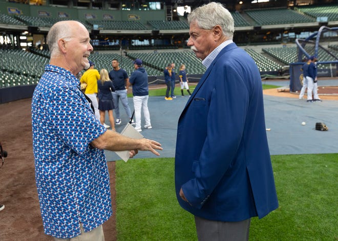 Milwaukee Journal Sentinel reporter Tom Haudricourt, left, speaks with Milwaukee Brewers general manager Doug Melvin before their game against the New York Mets Friday, September 24, 2021 at Miller Park in Milwaukee, Wis.