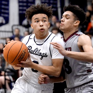 West York's Jaden Walker drives with pressure from  Shippensburg's Trae Kater during a District 3 Class 5-A semifinal at West York Monday, Feb. 28, 2022. West York would lose 51-49 in a triple overtime contest. Bill Kalina photo
