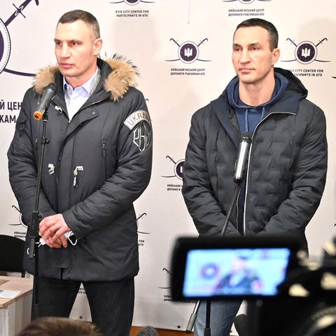 Vitali, left, and Wladimir Klitschko speak to the 