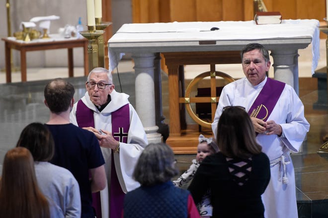 Father David Arnoldt (left) and Deacon Ken Maleck celebrate Mass in observance of Ash Wednesday at St. Mary on the Hill Catholic Church on Wednesday, which marks the start of the 40-day period of Lent for Christians.