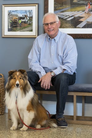 Former New Albany law director Mitch Banchefsky sits inside Village Hall with his Shetland sheepdog, Winston, on Feb. 28.
