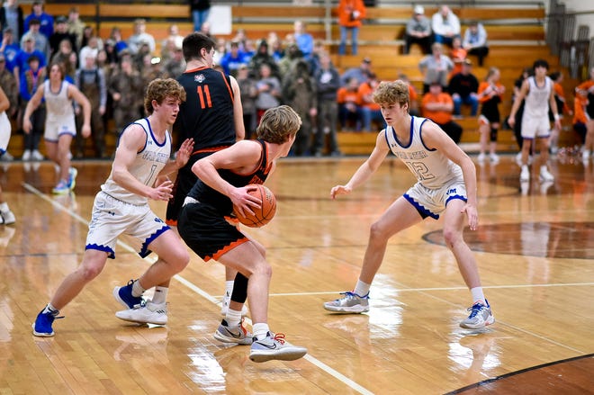 Carter Durflinger (1) and Aydn Netten (12) guard a Red Oak player during the substate championship on Saturday, Feb. 26.