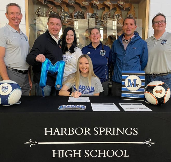 Harbor Springs senior Ella Morrow will play soccer at Marian University in Wisconsin. Joining Ella in the photo are her parents Rob and Dana, high school coach Aaron Riley, Breakers Coaches Mike Youngs and DJ Jones and Director of Coaching and Breakers Coach, Ashley Antonishen.