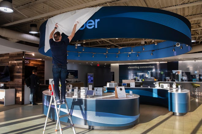 Mike Morrison, employee of altafiber, formerly Cincinnati Bell, changes the signage at the Kenwood store to reflect the new name, Wednesday, March 2, 2022.