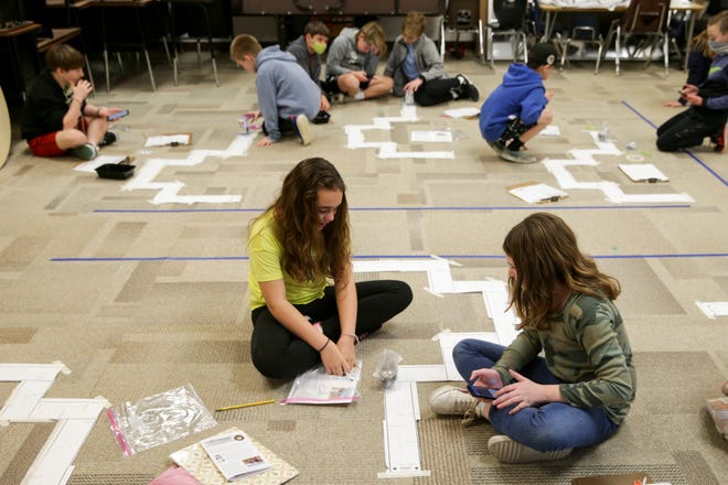 Fifth-graders from Hershey Elementary work to program their robotic sled dogs, Wednesday, March 2, 2022 in Lafayette.