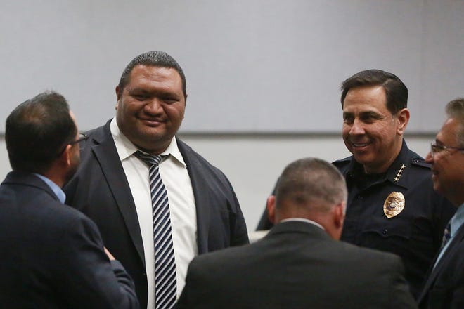 Las Cruces City Manager Ifo Pili, left, and Las Cruces Police Chief Miguel Dominguez chat in a group after the State of the City Address on March 2, 2022.